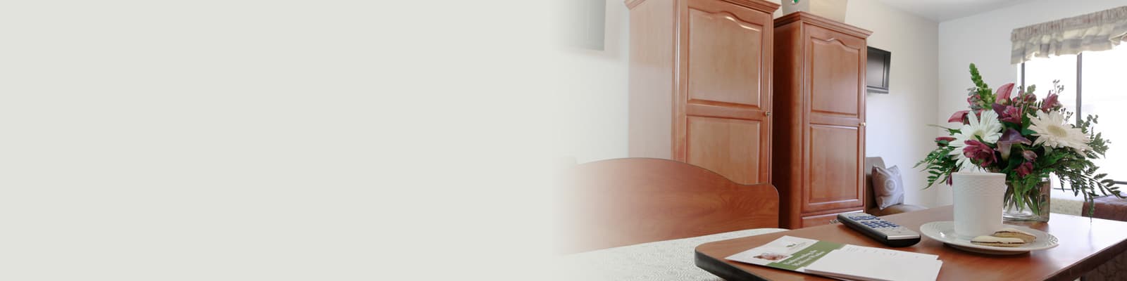 A patient's bed with flowers next to it