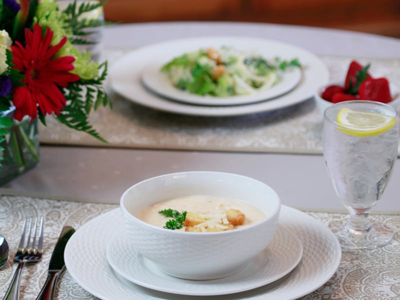 A bowl of soup and a plate of salad at the restaurant at Auburn Oaks