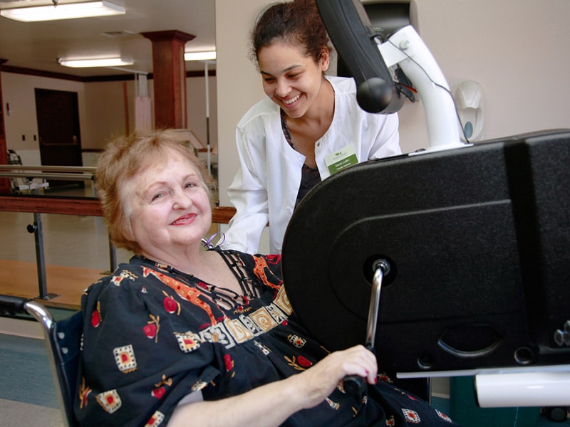 A patient doing therapy with a PT at Auburn Oaks