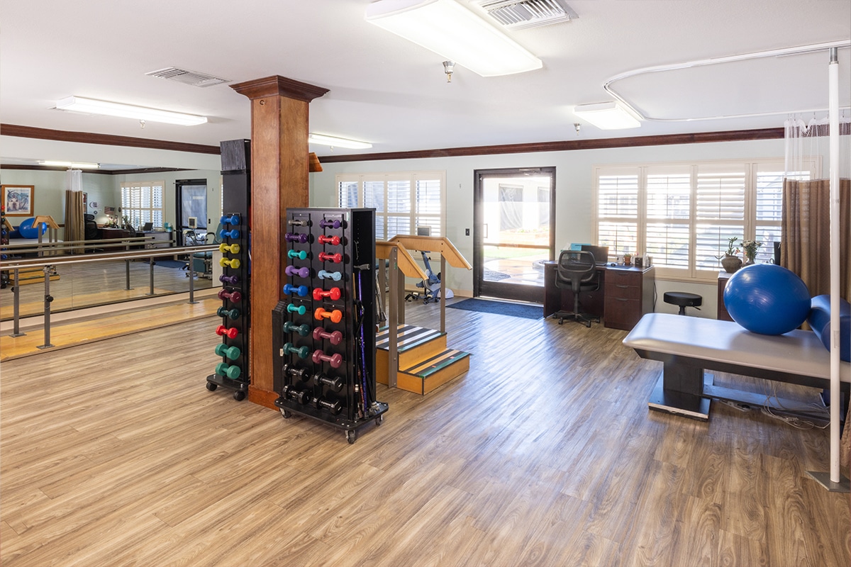auburn oaks large gym with colorful weights and wood flooring