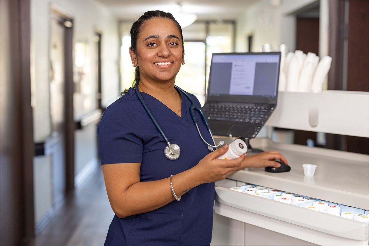 auburn oaks nurse in blue scrubs smiling