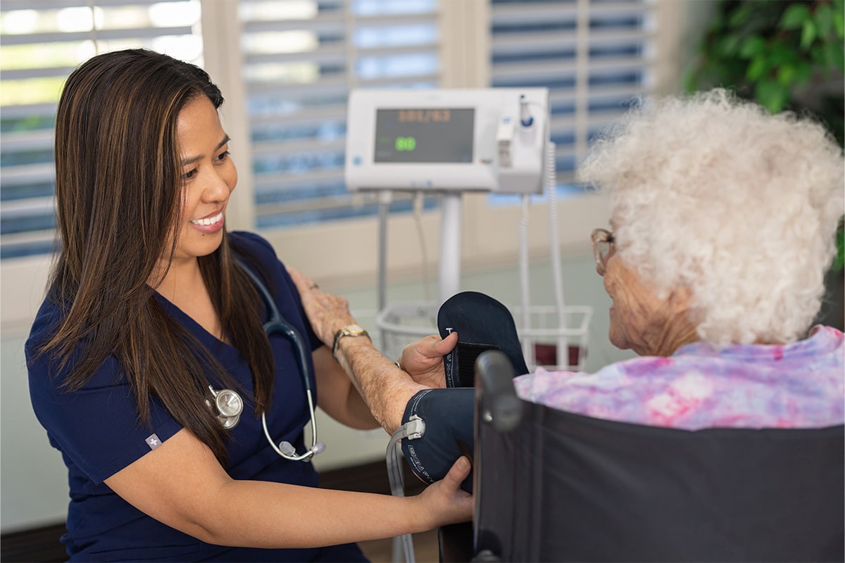 PACS-300x200-caregiver4 auburn oaks nurse taking elderly woman's blood pressure