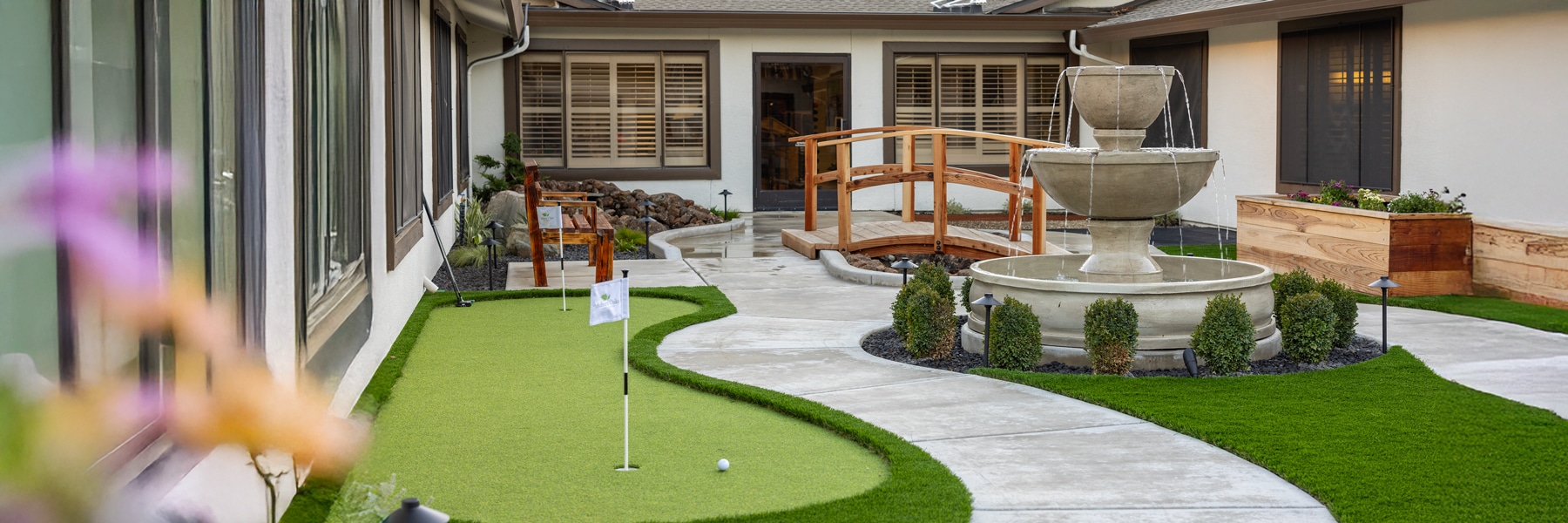 green lawn and mini golf course with fountain at auburn oaks care center