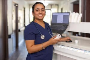 nurse standing at computer at auburn oaks care center