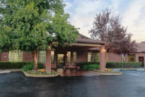 exterior view of the front entrance of auburn oaks care center building